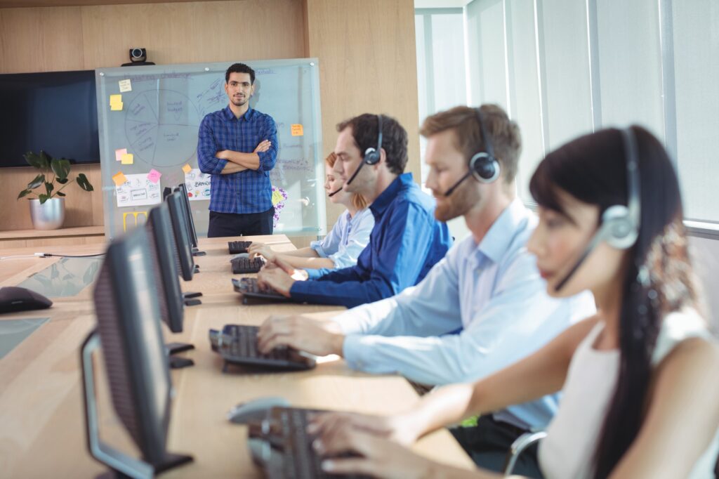 Manager with business team working at call center