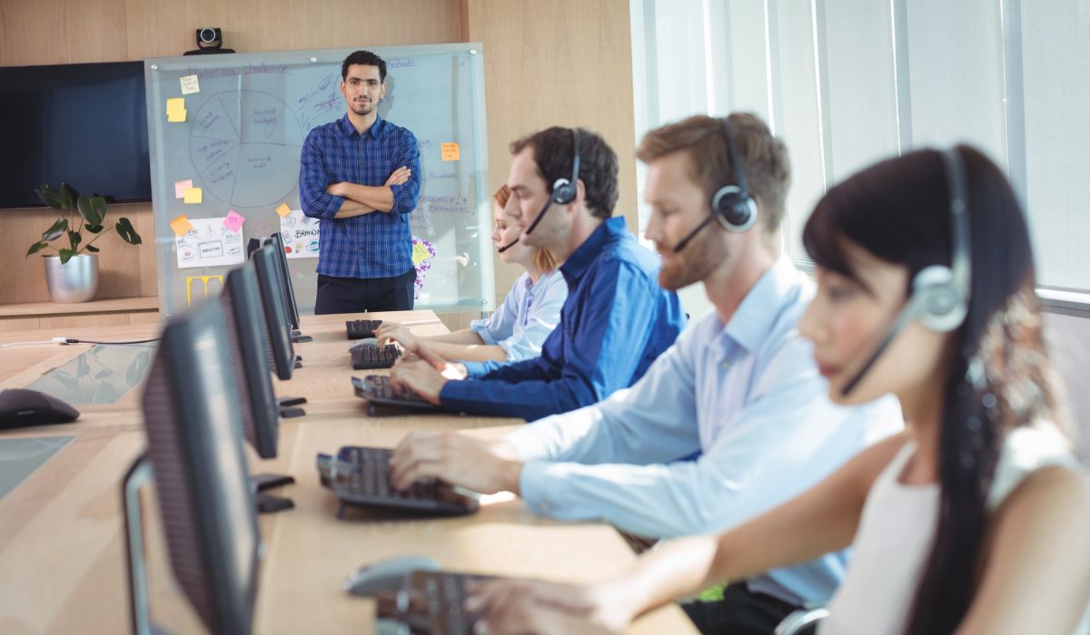 Manager with business team working at call center